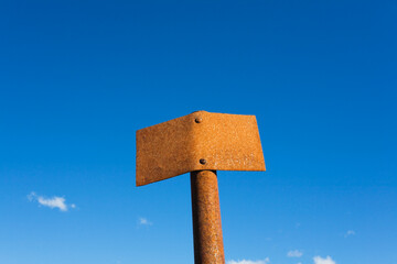 Rusty signpost under blue sky in Tongariro National Park New Zealand