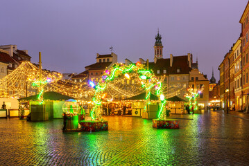 Christmas market lights and decorations in Old Town square in Warsaw Poland during winter evening