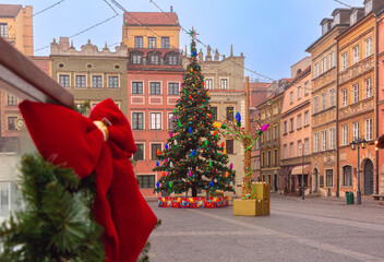 Decorated Christmas tree and historic townhouses in Old Town square in Warsaw Poland during winter