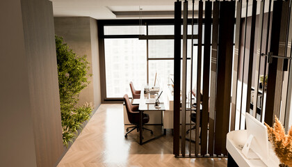 Modern office workspace with computers near reception and counter