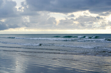 Fototapeta premium Moody seascape with layered clouds, low light on the water, and a calm distant horizon, Kuala Penyu, Sabah, Malaysia.