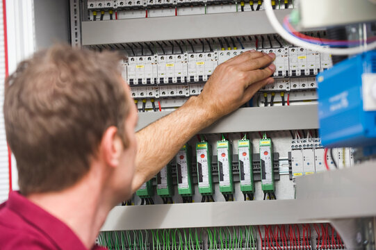 Technician inspecting photovoltaic control cabinet in Munich Germany