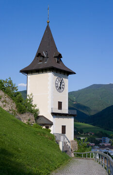 Clock tower in Bruck an der Mur Styria Austria with mountain landscape