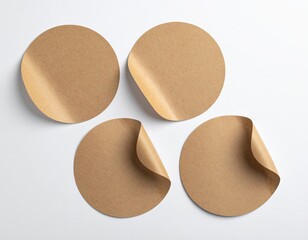 Brown paper circles with peeling corners on a white surface