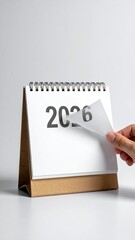 Desk calendar with 2026 being unveiled