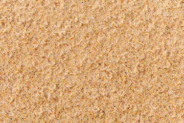 Natural beach sand texture background with fine grains and warm tones. Minimal, organic surface ideal for summer, travel, nature, design mockups, wallpapers, and copy space concepts
