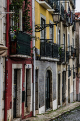 Colourful facades in a narrow alley in the old town of Lisbon, Portugal.