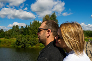 A smiling couple in love, relaxing in nature on a sunny summer day.