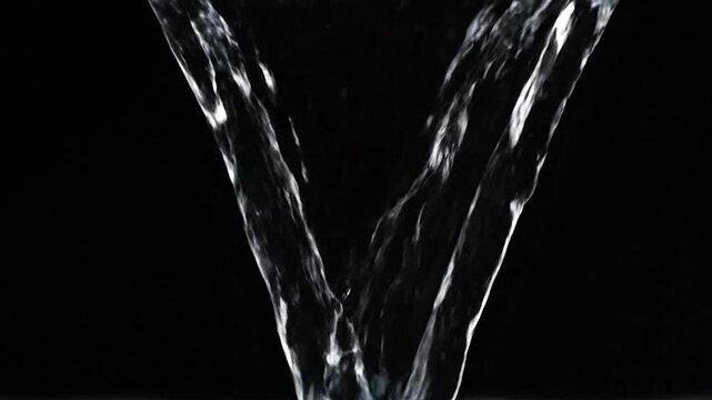 Water streams, flowing downward in a V shape against a dark, contrasting background