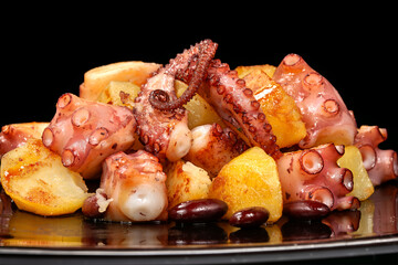 Galician dish Polbo a feira with octopus, potatoes, and spices served on a plate in a traditional setting