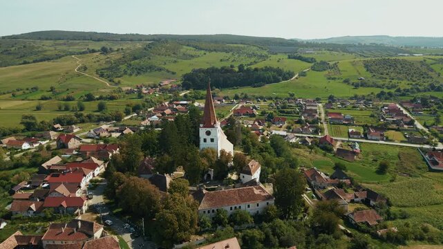 Aerial View Of Fortified Church With Rural Landscape In Cincu, Brasov, Romania. - pullback shot