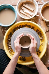 Artist shaping clay on a spinning potter's wheel, surrounded by water and wooden tools. Use: artisanal lifestyle magazine, product catalog for.