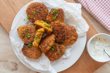 Vegetarian red lentil rice fritters with cheese and dip fresh and homemade cooked