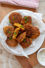 Homemade vegetarian, red lentil, rice, cheese fritters on a plate