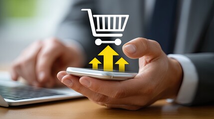 User engages in online shopping on a smartphone while sitting at a laptop during the evening