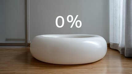 A minimalist white round dog bed sits on a wooden floor with a zero percent sign displayed above it in natural light