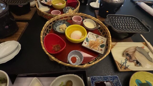 Man in a yukata robe enjoying a kaiseki, a traditional multi course Japanese dinner