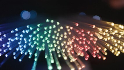 Vibrant fiber optic cables illuminate a dark space with a mesmerizing array of rainbow colors showcasing the intricate beauty of highspeed data transmission and modern digital connectivity creating a.