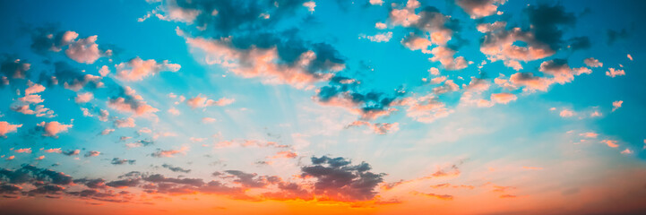 Panorama Sunset Sunrise Sky Background. Natural Bright Dramatic Sky In Sunset Dawn Sunrise. Yellow And Blue Colors. Panoramic View