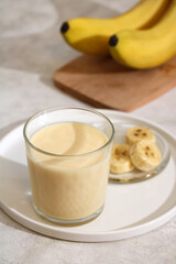banana yogurt in glass, healthy nutritious milk and fruit drink