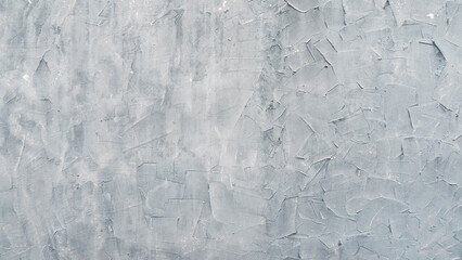 Heavy textured gray plaster wall background with trowel marks.