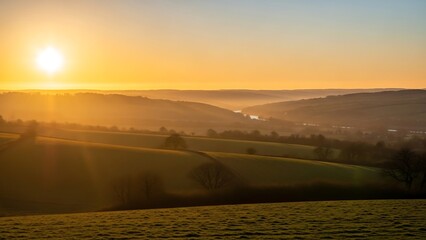 Sunset over rolling hills landscape scene.