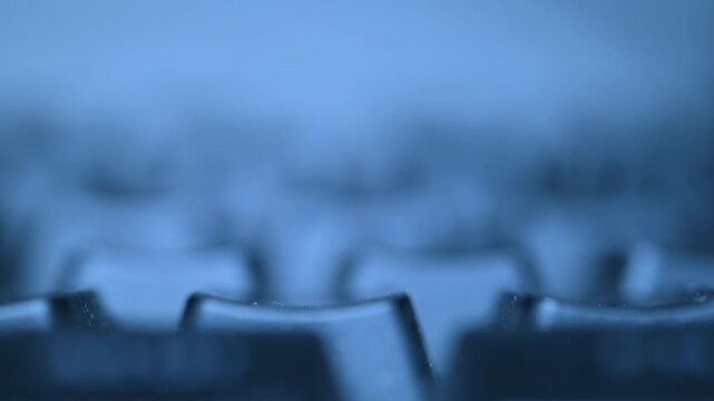 Blue toned macro view of computer keyboard keys