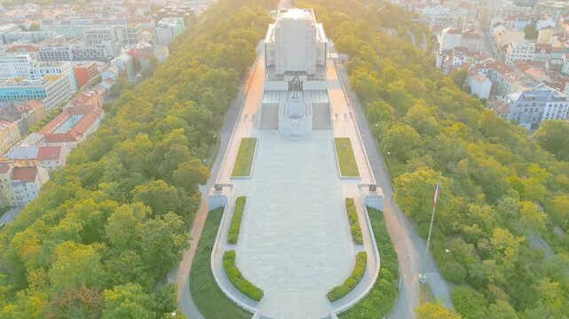 At sunrise, Vitkov Hill reveals the grandeur of the National Monument dedicated to Jan Zizka. The serene surroundings and lush greenery enhance this iconic site in Prague.