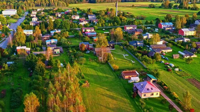 Scattered houses, yards, and gardens in the residential outskirts of Vaidava, Latvia