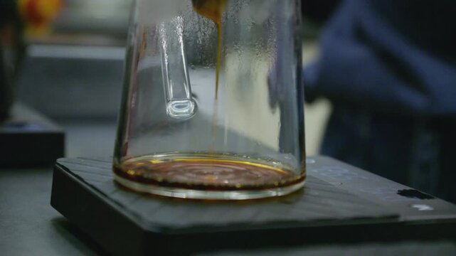 Coffee brewing process with pour over dripper and espresso extraction in cafe environment, hot fresh coffee preparation