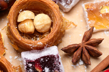Fototapeta premium Close up of oriental nest sweet with nuts star anise and Turkish delight