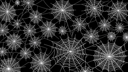 Intricate spiderweb pattern on a stark black background creating a spooky ambiance