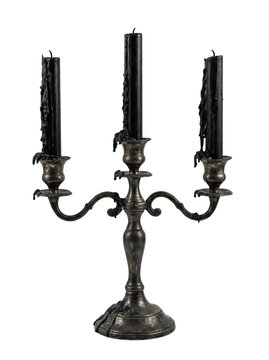Antique silver candelabra with dripping black wax candles