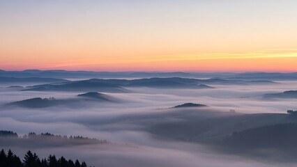Obraz premium Serene mountain landscape with foggy valleys.