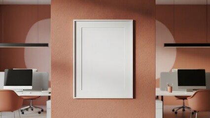 Vertical white picture frame mockup on a textured terracotta wall in a contemporary minimalist office with modern desks, computers, and ergonomic chairs, perfect for artwork.