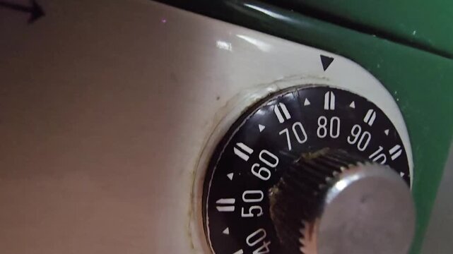 Macro shot of a vintage mechanical combination dial on a metal security box.
