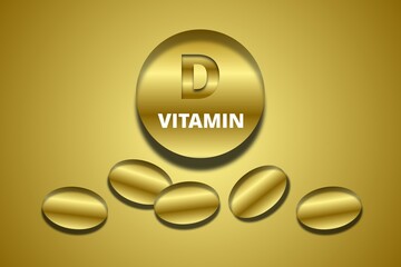 Vitamin D supplement capsules on golden background