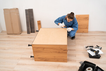 craftsman assembles furniture at home. Professional furniture assembling concept