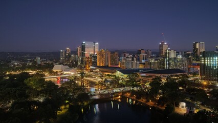 Obraz premium Adelaide City, South Australia – Aerial Drone View of Night Skyline, Riverbank Precinct, Festival Lights, Urban Cityscape Along River Torrens