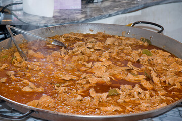 Portuguese Meat Stew (Bifanas) with Bay Leaves Cooking in Large Paella Pan