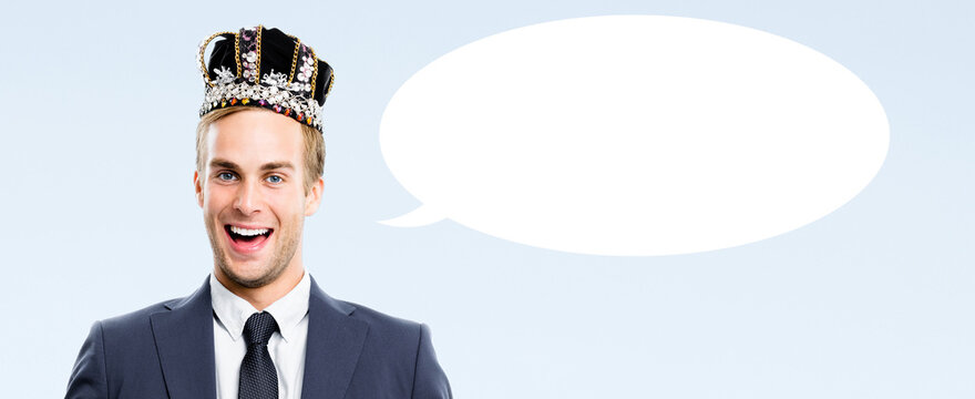 I am business king! Portrait - happy smile businessman man wear crown isolate light blue background with white empty mockup speech bubble blank free text space. Leadership, success deal ad concept
