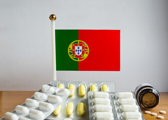 Flag of Portugal with Pills and Capsules. Pharmaceutical Concept
