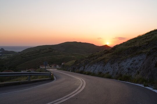 Winding road on limnos island during sunset