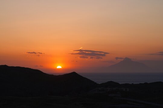 Sunset over limnos island with mount athos