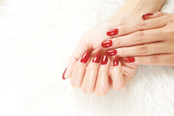 woman hands with colorful red and decorated nail manicure with modern, innovative and elegant shapes. Nails and manicure.
