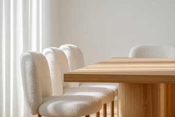 Modern dining room featuring a wooden table and cozy white upholstered chairs with natural light highlighting the minimalist and elegant interior design elements