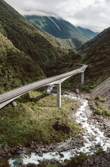 Otira Viaduct Bridge Above Mountain Stream in Lush Alpine Valley, New Zealand