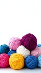Colorful yarn balls in vibrant pink, blue, yellow, purple and white arranged on white background for knitting and crochet crafts projects.