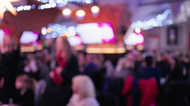 Diners seated at spacious table under calming ambient lights with service staff visible in relaxed environment