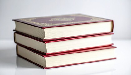 Stack Of Three Burgundy And Gold Hardcover Books With Gilded Edges On A White Surface